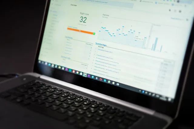 A laptop displaying an analytics dashboard with real-time data tracking and analysis tools. CRM buyer personas as versioned hypotheses with expiry rules