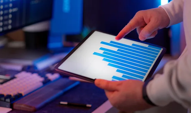 Business professional analyzing bar chart on tablet in office setting, highlighting data insights. CRM metrics with explicit events, populations and decision triggers