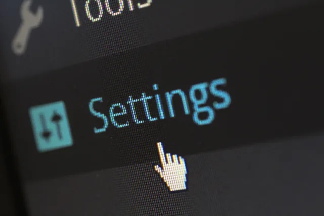 A close-up photo of a computer screen showing the settings button with a cursor hovering over it. CRM quality checks on records, permissions, workflow and recovery before launch
