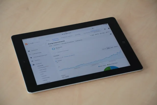 A digital tablet showing a web analytics dashboard with graphs and charts. Building a CRM dashboard where every panel explains itself